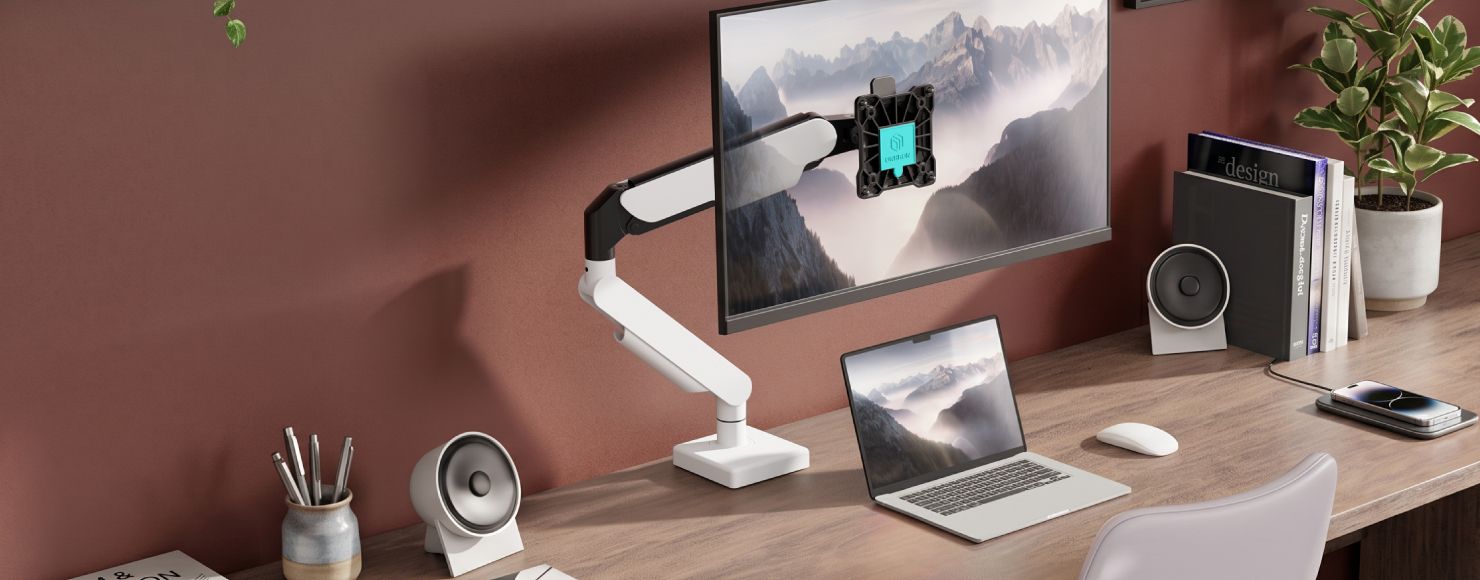 Home study setup with a monitor mounted on an ONKRON desk arm